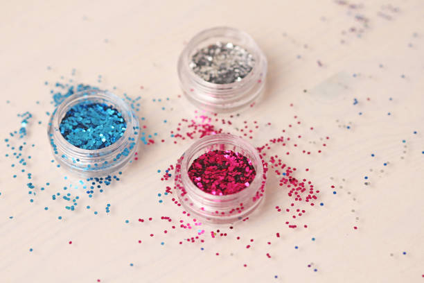 Multi-colored Sequins for the design of nails in a box. Glitter in jars. Foil for nail service. Photo set. Sparkling beauty shimmer, glitter.